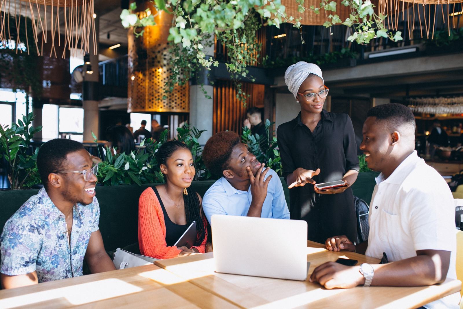 African team collaborating around a laptop